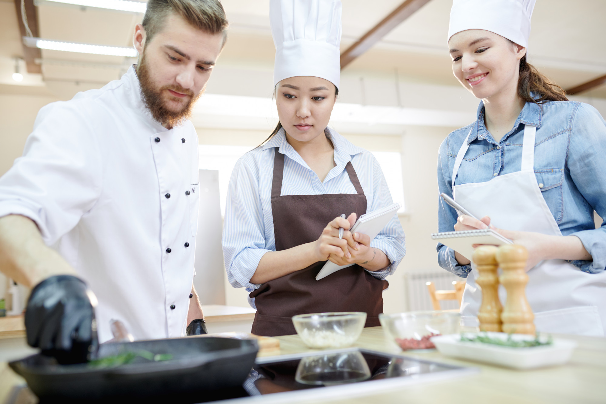 Chef teaching a small group in a kitchen studio